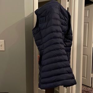 LANDS’ END thin puffer vest with length and shape at the waist.